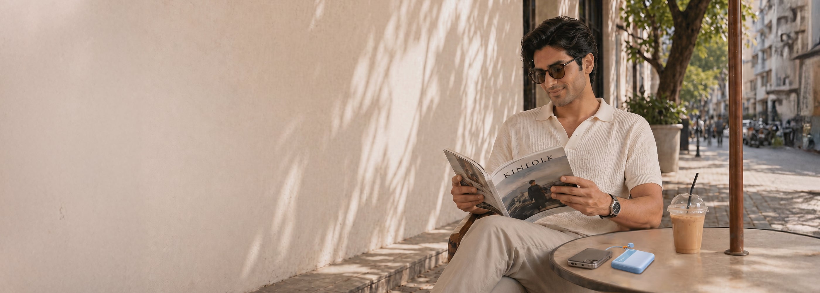 Man reading a newspaper outdoors on a sunny day